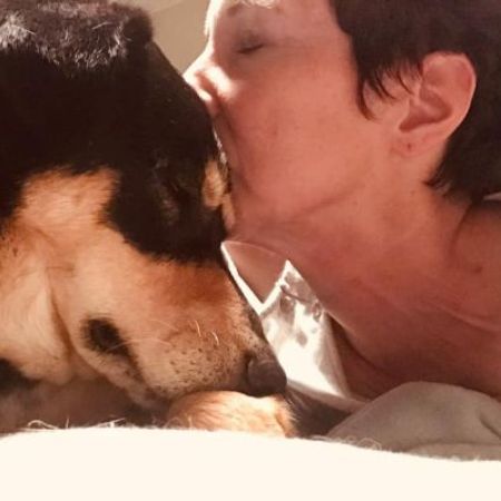 April Nocifora kissing her dog forehead
